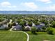 Scenic aerial view of a neighborhood with mature trees and view of the mountains in the distance at 885 Sage Sparrow Cir, Highlands Ranch, CO 80129