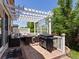 Inviting outdoor patio with pergola, dining set, and grill, perfect for entertaining at 885 Sage Sparrow Cir, Highlands Ranch, CO 80129