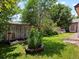 Green backyard with a planter, trees, and well-maintained lawn at 885 Sage Sparrow Cir, Highlands Ranch, CO 80129