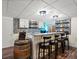Basement bar area with a barrel, countertop seating, and white cabinets at 885 Sage Sparrow Cir, Highlands Ranch, CO 80129