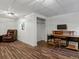 Finished basement with wood-look floors, workspace, and a comfortable recliner at 885 Sage Sparrow Cir, Highlands Ranch, CO 80129
