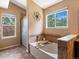 Bright bathroom featuring tub, shower, and large window offering a pleasant view at 885 Sage Sparrow Cir, Highlands Ranch, CO 80129