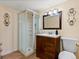 Cozy bathroom with a glass-enclosed shower and dark wood vanity at 885 Sage Sparrow Cir, Highlands Ranch, CO 80129