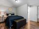 Comfortable bedroom with wood floors, stylish furnishings, and a padded ottoman at 885 Sage Sparrow Cir, Highlands Ranch, CO 80129