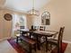 Bright dining room with a large wooden table set below an elegant light fixture at 885 Sage Sparrow Cir, Highlands Ranch, CO 80129