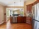 Spacious kitchen with stainless steel appliances and hardwood floors that opens to living room at 885 Sage Sparrow Cir, Highlands Ranch, CO 80129