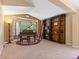 Cozy living room featuring a beautiful bay window, piano, and custom bookshelf at 885 Sage Sparrow Cir, Highlands Ranch, CO 80129