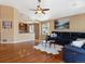 Open-concept living room with hardwood floors that flows into the kitchen at 885 Sage Sparrow Cir, Highlands Ranch, CO 80129