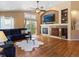 Spacious living room with hardwood floors, fireplace, and backyard views at 885 Sage Sparrow Cir, Highlands Ranch, CO 80129