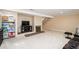 Open basement area with cozy fireplace, adjacent to the stairs, and extra built-in shelving at 7755 E Quincy Ave # T80, Denver, CO 80237