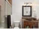 Well-lit bathroom featuring dark granite vanity and glass shower at 7755 E Quincy Ave # T80, Denver, CO 80237