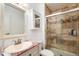 Tiled bathroom featuring a granite vanity and glass shower at 7755 E Quincy Ave # T80, Denver, CO 80237