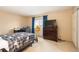 Bedroom featuring a large bed, desk, dresser and natural light from the window at 7755 E Quincy Ave # T80, Denver, CO 80237