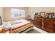 Sunlit bedroom with a dresser and window at 7755 E Quincy Ave # T80, Denver, CO 80237
