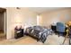 Bedroom features a bed, desk, and neutral walls at 7755 E Quincy Ave # T80, Denver, CO 80237