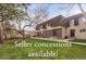Townhouse with brick facade and lush green lawn at 7755 E Quincy Ave # T80, Denver, CO 80237