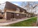 Charming townhome featuring a brick facade and landscaped entrance, creating a warm welcome at 7755 E Quincy Ave # T80, Denver, CO 80237
