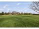 View of grass athletic field with tree-lined border and lightly cloudy sky at 7755 E Quincy Ave # T80, Denver, CO 80237