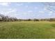 Expansive green field, partially shaded by trees, near a residential area on a partly cloudy day at 7755 E Quincy Ave # T80, Denver, CO 80237