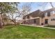 Inviting townhome with a well-manicured lawn and mature trees enhancing curb appeal at 7755 E Quincy Ave # T80, Denver, CO 80237
