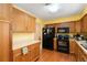 Efficient kitchen design with wooden cabinets and modern appliances, ideal for cooking at 7755 E Quincy Ave # T80, Denver, CO 80237