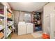 Functional laundry area with modern washer and dryer, additional storage, and plenty of space at 7755 E Quincy Ave # T80, Denver, CO 80237