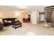 Open-concept living room with access to dining area and staircase at 7755 E Quincy Ave # T80, Denver, CO 80237