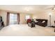 Spacious living room features a neutral color scheme, large windows, and comfortable seating at 7755 E Quincy Ave # T80, Denver, CO 80237