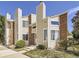 Inviting exterior showcases a charming townhouse with a combination of brick and cream-colored siding at 8114 Gray Ct # 478, Arvada, CO 80003