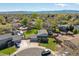 Aerial view of a home in a suburban neighborhood with mature trees and mountain views in the distance at 7367 Coors St, Arvada, CO 80005