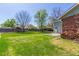 Large backyard with green grass and mature trees at 7367 Coors St, Arvada, CO 80005