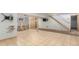 Finished basement with tile flooring, bar area, stairs, and a mounted television at 7367 Coors St, Arvada, CO 80005