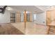 Spacious basement with tile flooring, wooden support beams, and built-in shelving at 7367 Coors St, Arvada, CO 80005