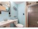 Light blue full bathroom featuring shower stall, toilet, and pedestal sink at 7367 Coors St, Arvada, CO 80005