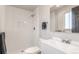 Bathroom features a walk-in shower with white subway tile, and a modern sink at 7367 Coors St, Arvada, CO 80005