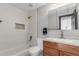 Modern bathroom with subway tile shower, stylish vanity, and granite countertops at 7367 Coors St, Arvada, CO 80005
