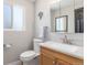 Modern bathroom with vanity, toilet, and mirror at 7367 Coors St, Arvada, CO 80005