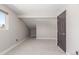 Bright bedroom with neutral walls, carpet, a large window, and attic access, offers great space at 7367 Coors St, Arvada, CO 80005