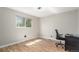 Bright bedroom with hardwood floors, ceiling fan, and a large window at 7367 Coors St, Arvada, CO 80005