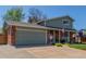 Two-story home with brick accents, a well-maintained lawn, and a two car garage at 7367 Coors St, Arvada, CO 80005