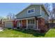 Charming two-story home with brick accents, manicured lawn, and a two car garage at 7367 Coors St, Arvada, CO 80005