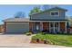 Charming two-story home with brick accents, a well-maintained lawn and a two car garage at 7367 Coors St, Arvada, CO 80005
