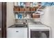Laundry room with side-by-side washer and dryer and shelving at 7367 Coors St, Arvada, CO 80005