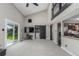 Bright, open living room with vaulted ceilings, modern barn door, and access to backyard at 7367 Coors St, Arvada, CO 80005