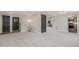 Spacious living room with neutral carpet, gray doors and trim, and access to the kitchen at 7367 Coors St, Arvada, CO 80005