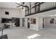 Open-concept living room with vaulted ceilings, modern barn door, and adjacent kitchen at 7367 Coors St, Arvada, CO 80005