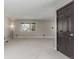 Bright living room featuring neutral carpet, large windows, gray doors and trim at 7367 Coors St, Arvada, CO 80005