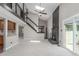 Bright living room with vaulted ceilings, skylight, fireplace, stairs to second story, and kitchen at 7367 Coors St, Arvada, CO 80005