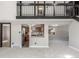 Bright living room features an open floor plan with brick accents and views into the kitchen at 7367 Coors St, Arvada, CO 80005