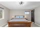 This primary bedroom includes a ceiling fan, two windows, and neutral colors at 7367 Coors St, Arvada, CO 80005